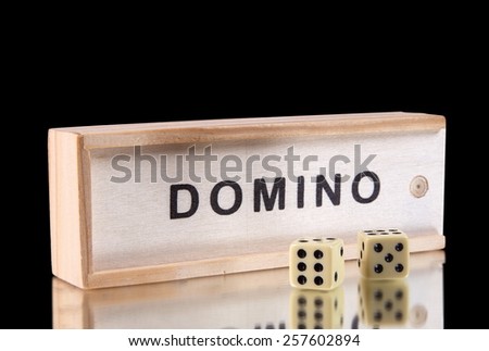 domino game in the wooden box on black