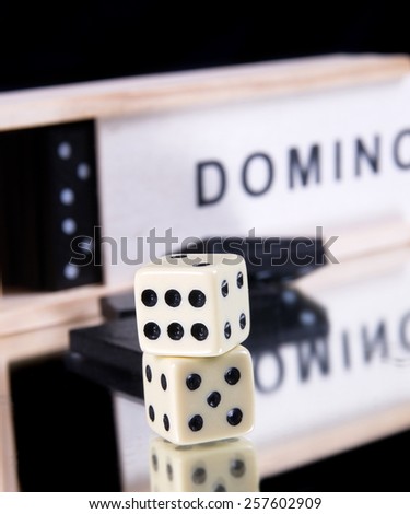 domino game in the wooden box on black