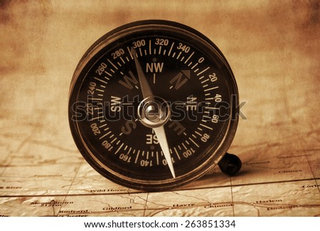 compass in the open map atlas,vintage texture