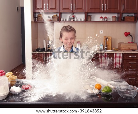 little girl is helping to bake  in a messy  kitchen