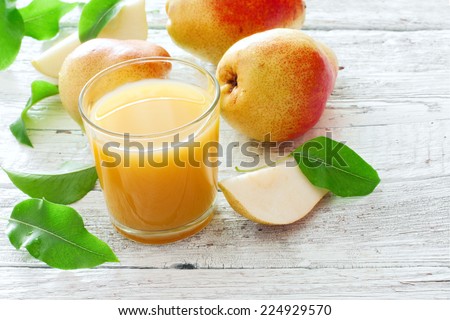 Pear juice and pears over white wood background