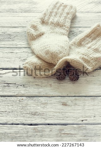 Handmade knitting socks over white wood background