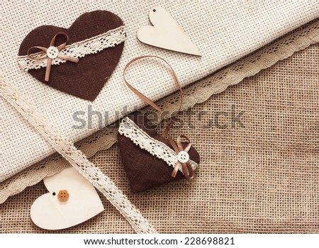 Scrapbook craft materials - laces, hearts, over canvas background