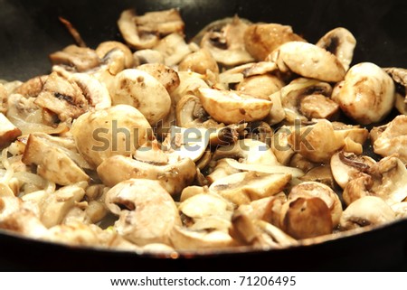 fried mushrooms in oil in a frying pan