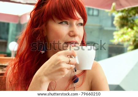 Young girl  with a cup of hot drink outside