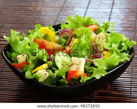 greek salad in black plate - stock photo