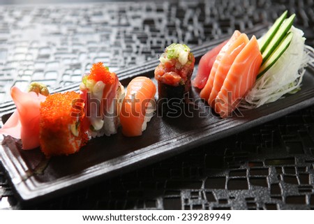 Japanese sushi roll on a black plate