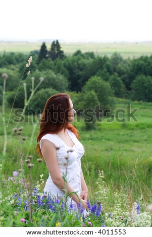 Beautiful woman at green meadow. Green trees. Summer