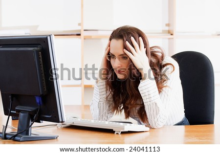 Businesswoman with problems before computer in office