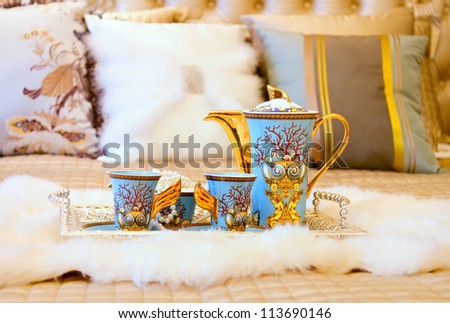 Closeup photo of Chinese beverage suite on wedding bed to celebrate the couple