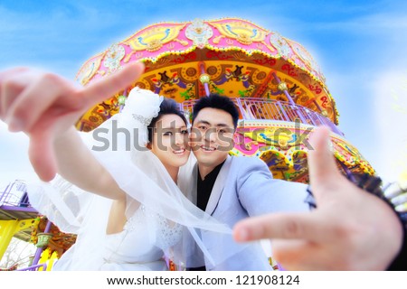 In this particular day we got married and this is a photo of us taken before the merry-go-round