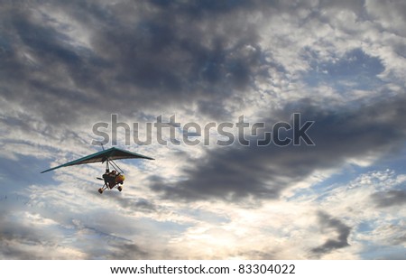 People glides in the sky with clouds, flying towards the Sun