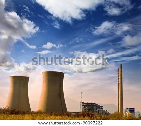 Landscape photo of industrial factory with power chimneys in blue sky in rural area