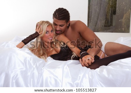 Playful sensual heterosexual couple - Caucasian woman and ethnic black man of mixed African-American and Italian ethnicity