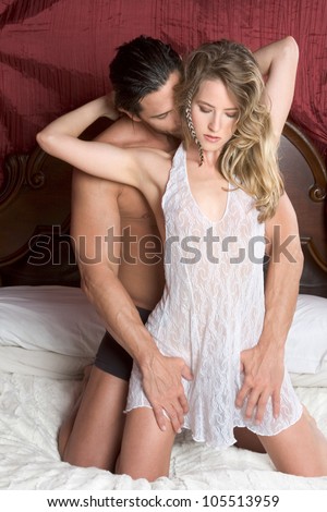 Young sexy naked heterosexual couple making love in bed