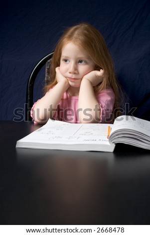 Redheaded girl with book by the black table