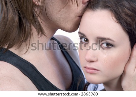 Man comforting crying distressed young woman in tears