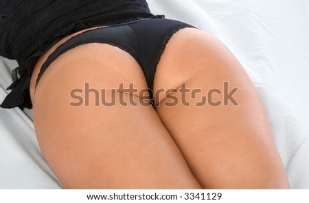 stock photo Female thighs in black Lingerie on the bed