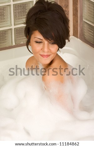 Sensual sexy girl relaxing in bath foam