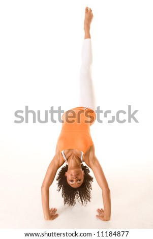 Dark skinned female stretching with one leg up in the air