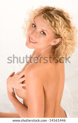 stock photo Sexy topless blonde is covering her breast by hands and ready