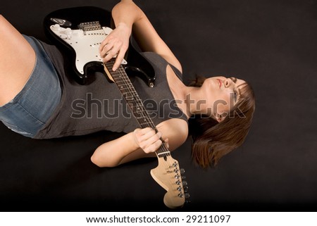 stock photo Young woman Guitarist with electric bass guitar