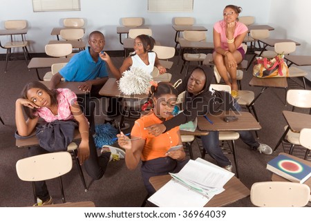High school classroom with six children, one boy and five girls, making chaos