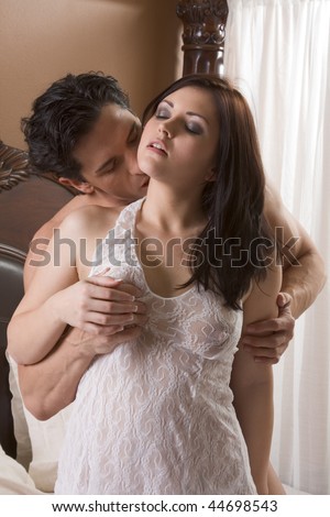 stock photo Young sexy naked heterosexual couple making love in bed