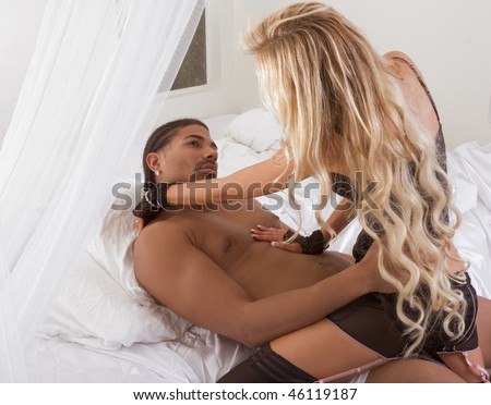 Playful sensual heterosexual couple - Caucasian woman and ethnic black man of mixed African-American and Italian ethnicity