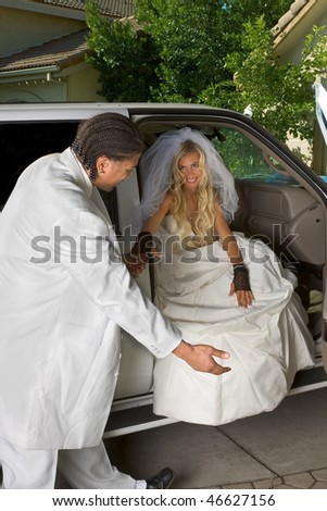  happy newlywed woman in white gorgeous wedding gown sitting in car