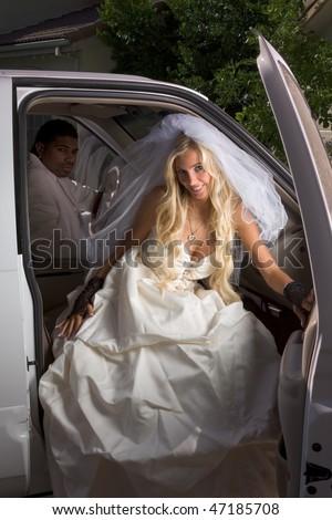  Caucasian happy woman in white gorgeous wedding gown sitting in car