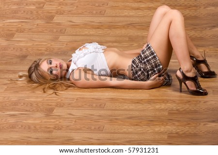 stock photo Blonde female pretending to be schoolgirl student in short 