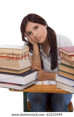 bored High school or college Latina female student sitting by the desk with pile of books in front of her