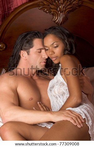 Lovers - Interracial sensual couple making love in bed