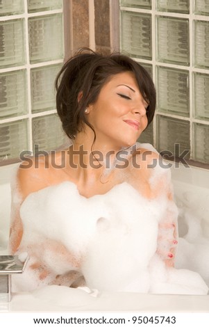 bathtub Sensual sexy female relaxing in hot tub bath with foam