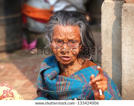 very old woman smoking cigarette