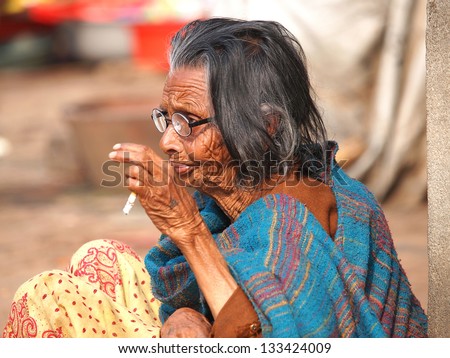 very old woman smoking cigarette