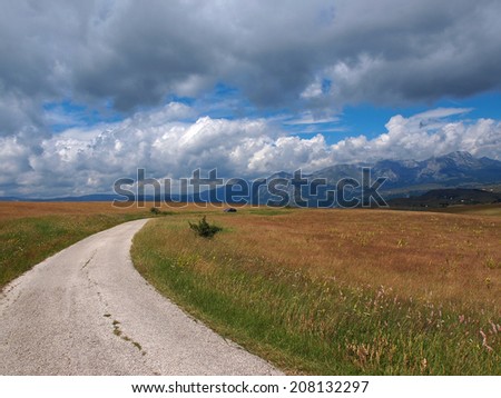 mountain road under the cloudy sky