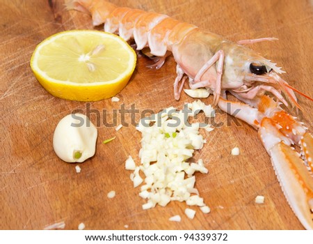 shrimp with lemon and garlic on  wooden cooking plate