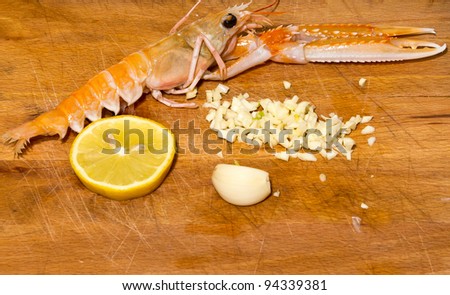 shrimp with lemon and garlic on wooden table