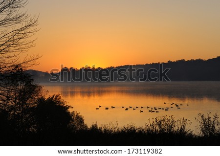 Sunrise Over Foggy Lake