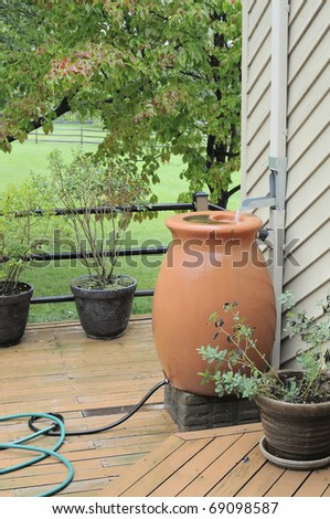 Rain Barrel being filled with water from roof