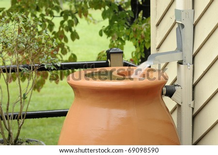 Rain Barrel being filled during rain storm