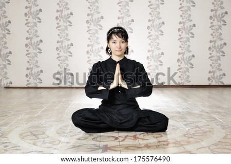 Young woman in the prayer lotus position.