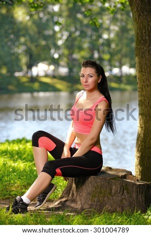 Tired woman runner taking rest after running workout in park