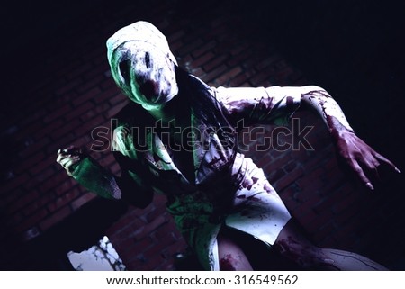 Crazy dead Silent Hill nurse with knife in hand