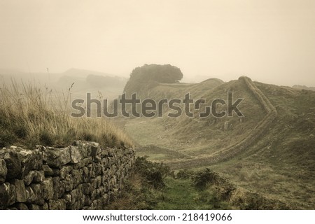 An early morning fog has descended over Hadrian\'s wall in Northumberland, England, close to the Scottish border.