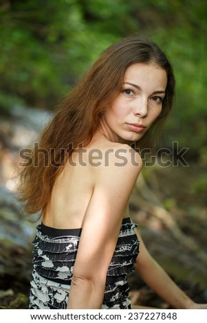 Fashion portrait of beautiful romantic young woman in the forest