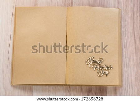 two empty pages of diary of craft paper with handmade wooden St. Valentine\'s greetings text