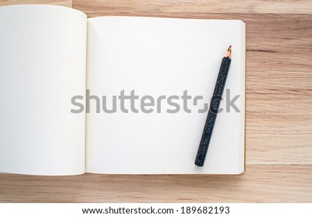 blank paper and pencil with multicolor pencil lead on wooden background
